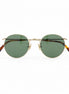 Round eyeglasses with gold frame and tortoiseshell accents on a white background