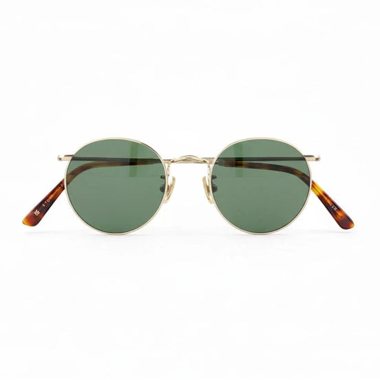Round eyeglasses with gold frame and tortoiseshell accents on a white background