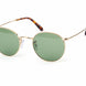 Round gold-framed glasses with tortoiseshell accents on a white background