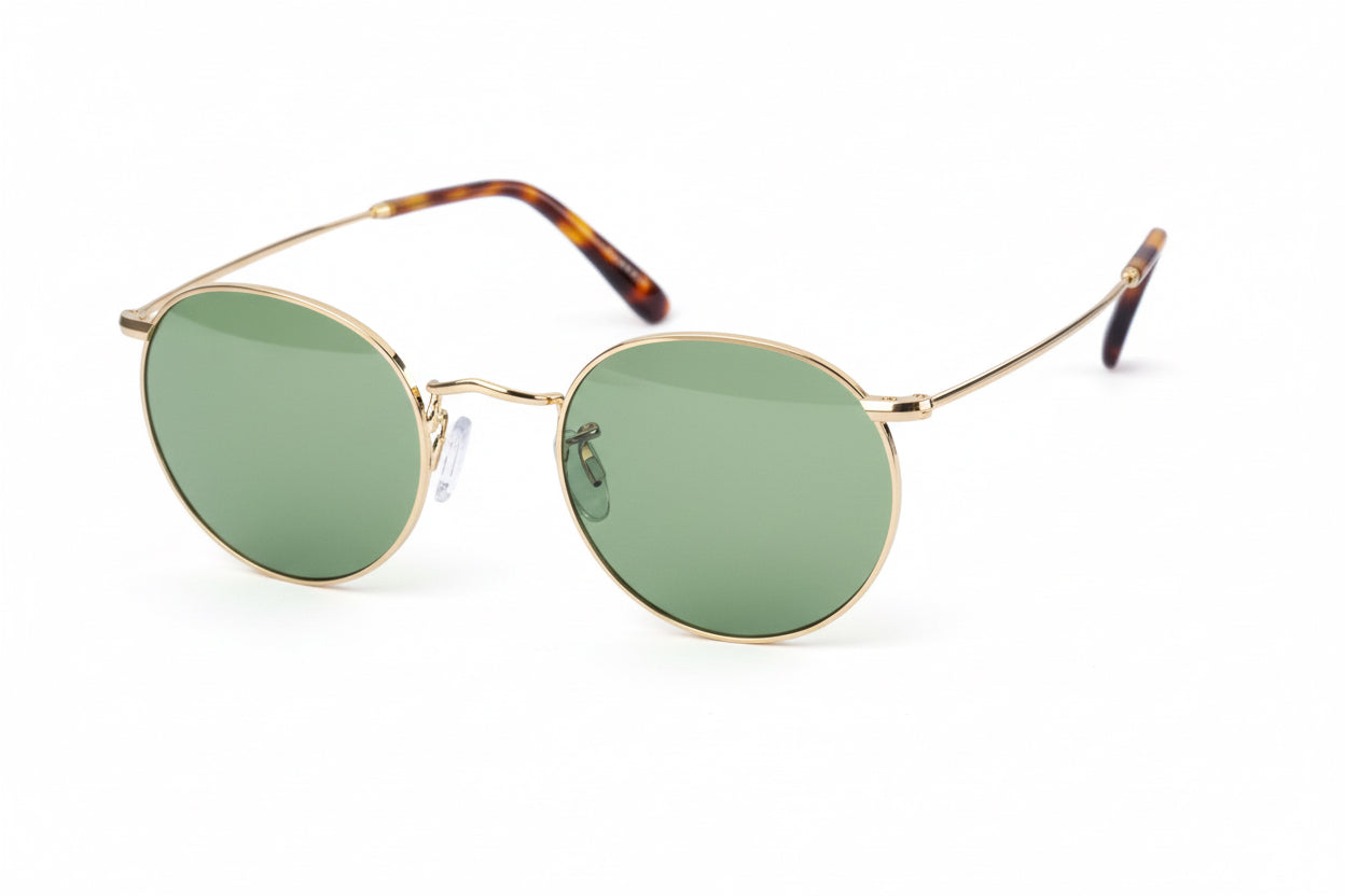 Round gold-framed glasses with tortoiseshell accents on a white background